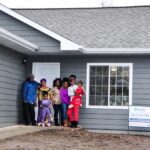 Pictured is the partner family in front of their finished home that was sponsored by Sammons Financial.