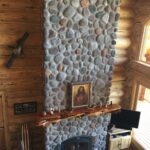 Large pudding stone fireplace in living room 